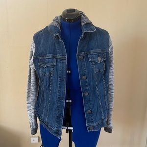 A torrid size 1X(14/16) blue jean jacket with a white knitted sleeve
